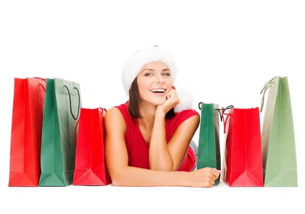 Woman in red shirt with shopping bags — Stock Photo, Image