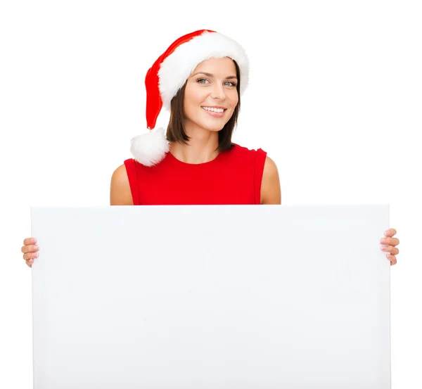 Vrouw in helper kerstmuts met een leeg wit bord — Stockfoto