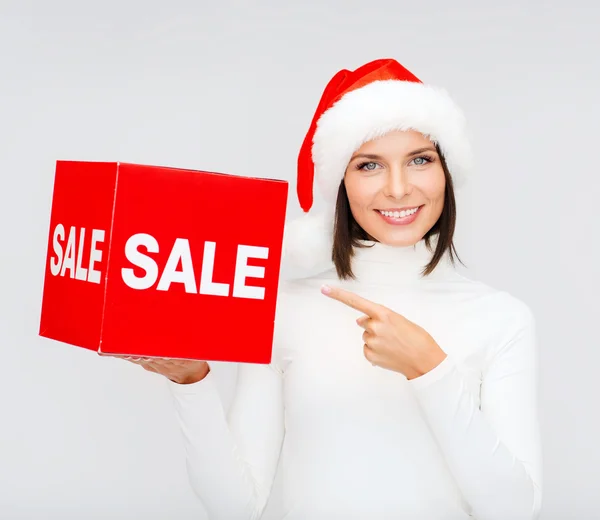Frau mit Weihnachtsmann-Helfermütze mit rotem Verkaufsschild — Stockfoto