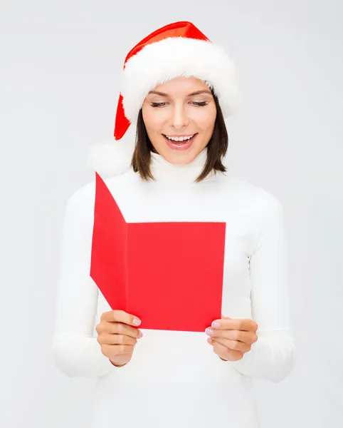 Woman in santa helper hat with blank red postcard Stock Photo