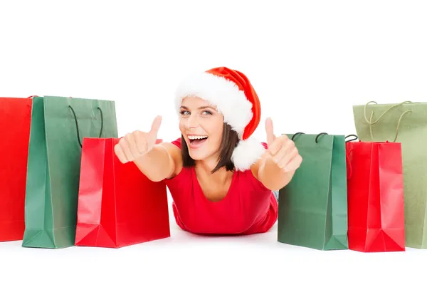 Woman in red shirt with shopping bags — Stock Photo, Image