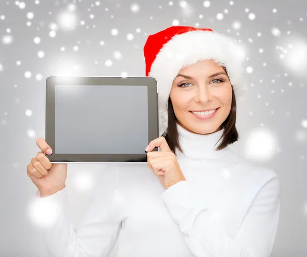 Frau mit Weihnachtsmann-Helfermütze mit Tablet-PC — Stockfoto