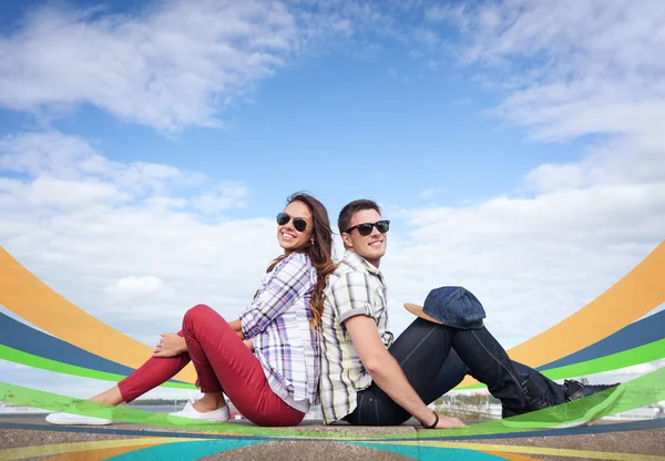 Teenagers sitting back to back — Stock Photo, Image