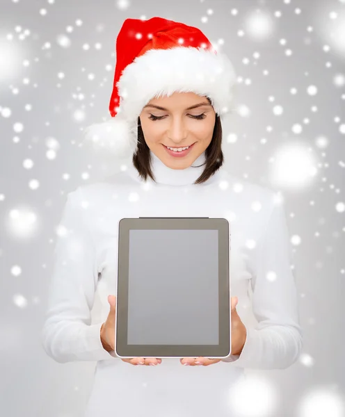 Kobieta w kapeluszu pomocnik santa z komputera typu tablet — Zdjęcie stockowe