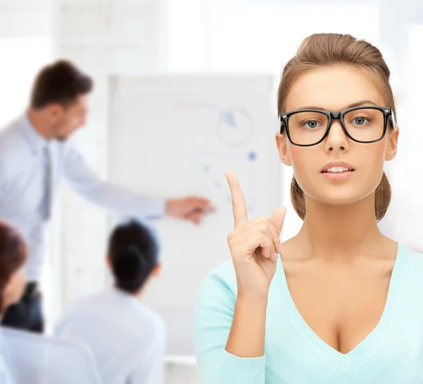 Attractive student wearing glasses in college — Stock Photo, Image