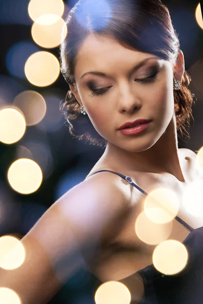 Woman in evening dress wearing diamond earrings Stock Picture