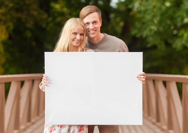 Romantic couple with blank white board — Stock Photo, Image