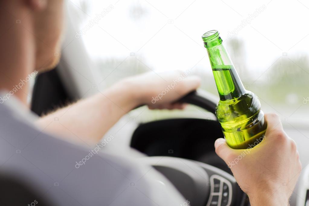 Man drinking alcohol while driving the car Stock Photo by ©Syda