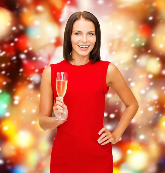 Woman in red dress with a glass of champagne — Stock Photo, Image
