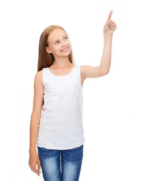 Girl in blank white shirt pointing to something — Stock Photo, Image