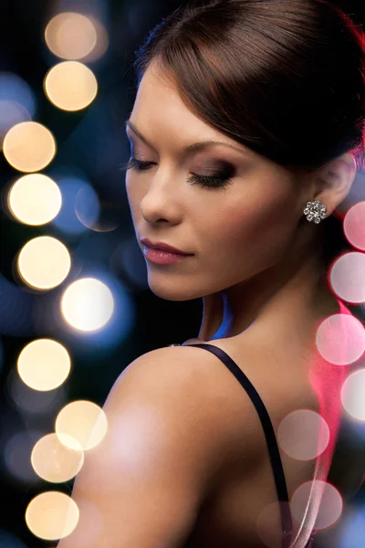 Woman in evening dress wearing diamond earrings Stock Picture