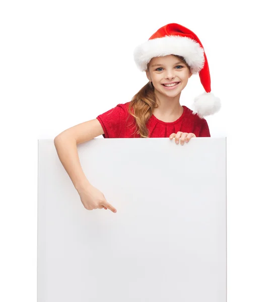 Vrouw in helper kerstmuts met een leeg wit bord — Stockfoto