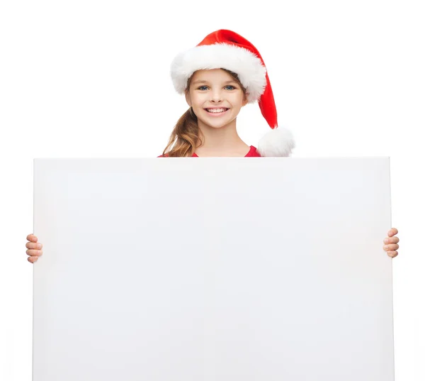 Vrouw in helper kerstmuts met een leeg wit bord — Stockfoto