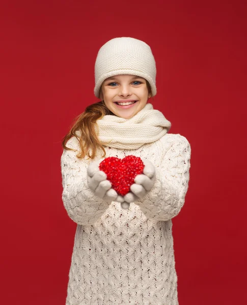 Girl in winter clothes with small red heart — Stock Photo, Image