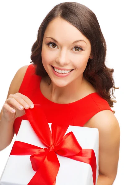 Smiling woman in red dress with gift box — Stock Photo, Image