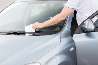 Parking ticket on car windscreen clipart