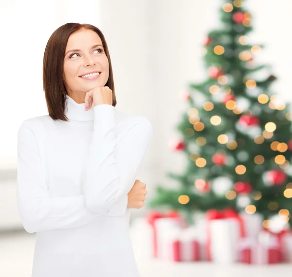 Thinking and smiling woman in white sweater — Stock Photo, Image