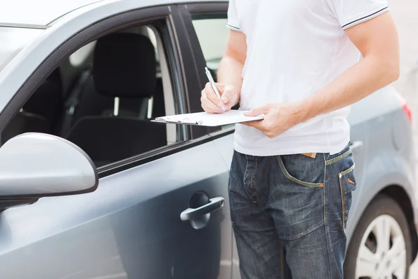 Man with car documents — Stock Photo, Image