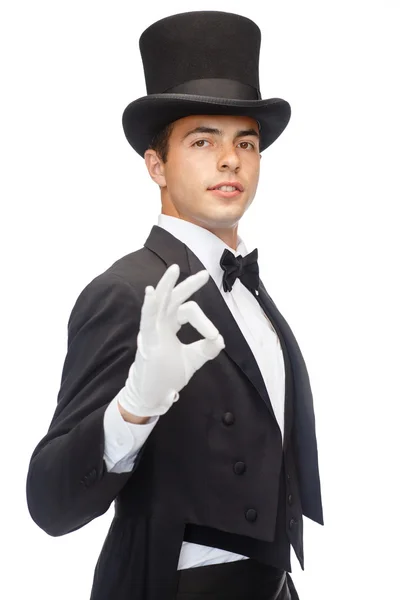 Magician in top hat showing trick — Stock Photo, Image