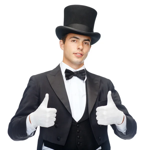 Mágico no chapéu superior mostrando polegares para cima — Fotografia de Stock