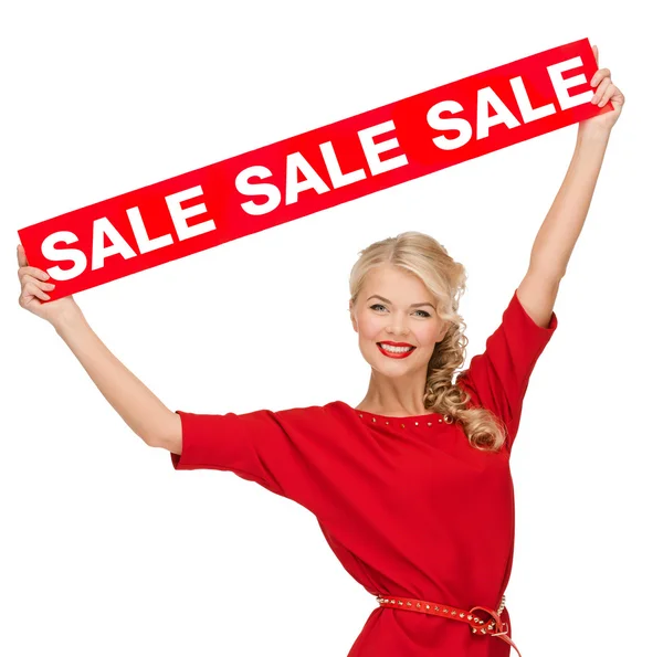 Žena v šatech s červenými prodej znamení — Stock fotografie