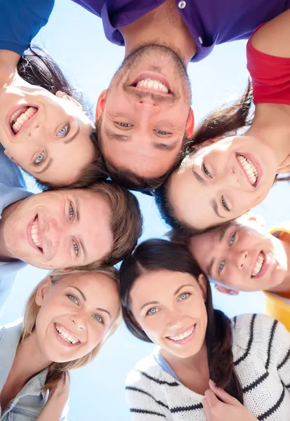 Group of teenagers looking down Stock Photo