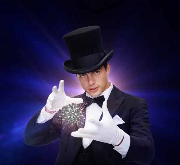 Magician in top hat showing trick — Stock Photo, Image