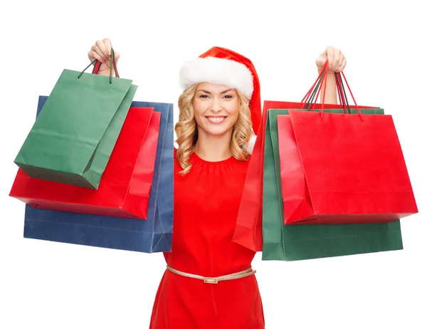 Woman in red dress with shopping bags — Stock Photo, Image