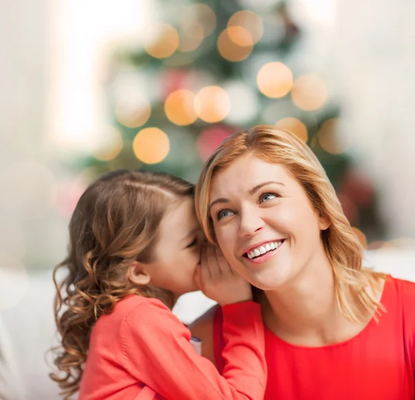 Mother and daughter whispering gossip — Stock Photo, Image
