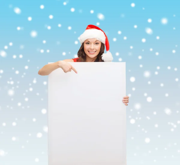 Žena v pomocníka čepice santa s prázdnou bílou tabuli — Stock fotografie
