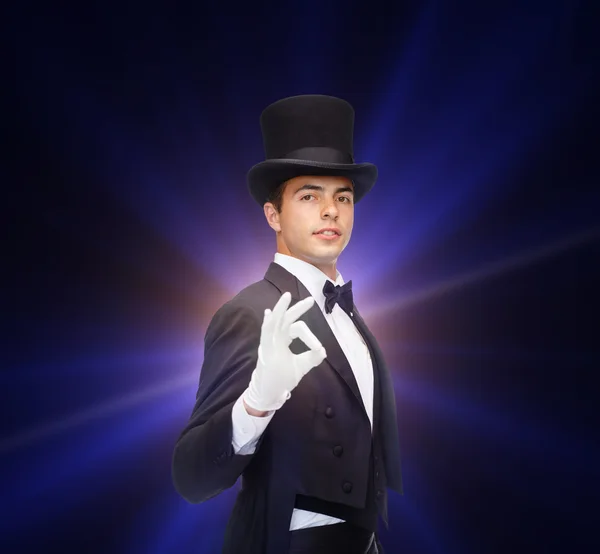 Magician in top hat showing trick — Stock Photo, Image