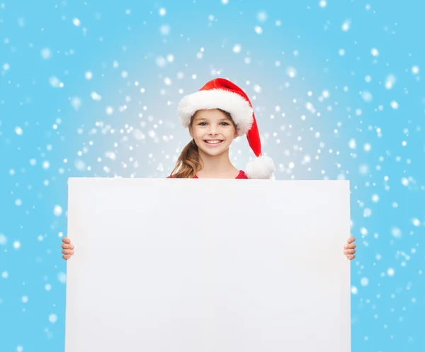 Vrouw in helper kerstmuts met een leeg wit bord — Stockfoto