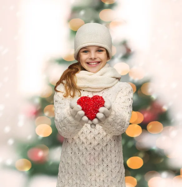 Girl in winter clothes with small red heart — Stock Photo, Image