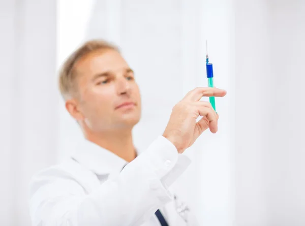 Mužský lékař držící injekční stříkačku — Stock fotografie
