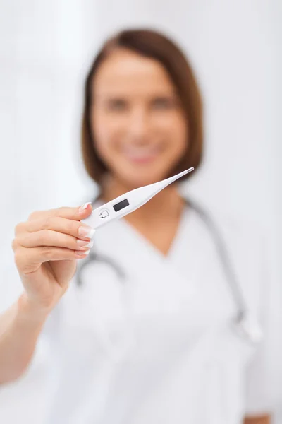 Doctor with thermometer and stethoscope — Stockfoto