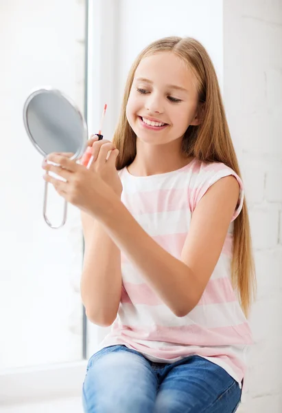 Teenage girl with lip gloss and mirror — Stock Photo, Image