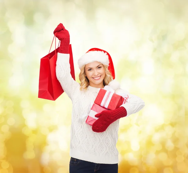 Woman in santa helper hat with shopping bags — Stock Photo, Image