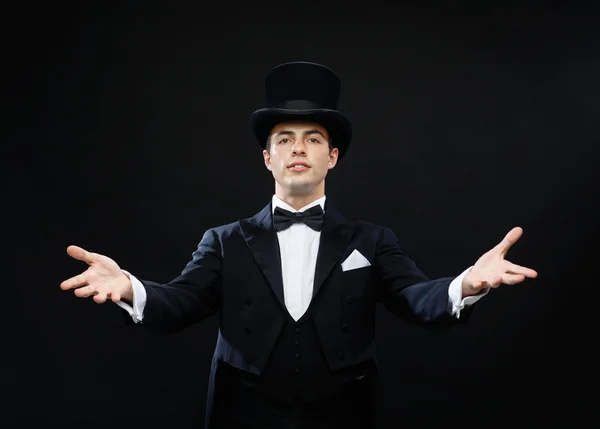 Magician in top hat showing trick — Stock Photo, Image