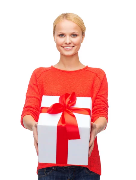 Femme souriante en pull rouge avec boîte cadeau — Photo