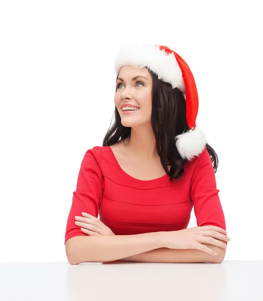 Surprised woman in santa helper hat looking up — Stock Photo, Image