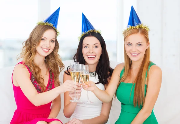 Tre donne che indossano cappelli con bicchieri di champagne — Foto Stock