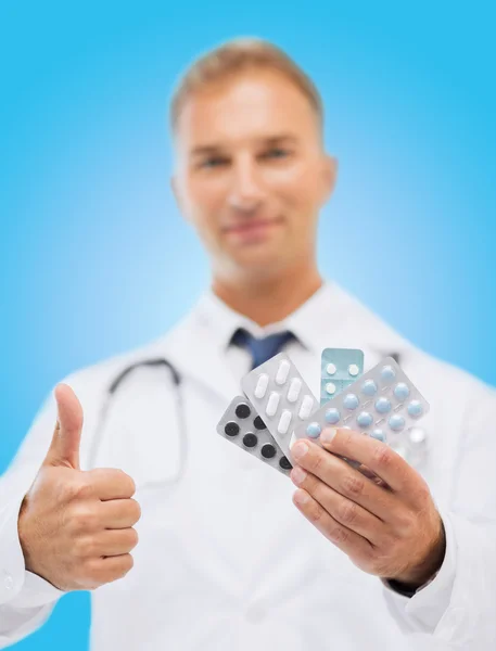 Male doctor with packs of pills — Stock Photo, Image