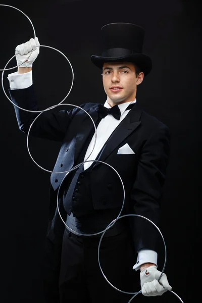 Magician showing trick with linking rings Royalty Free Stock Images
