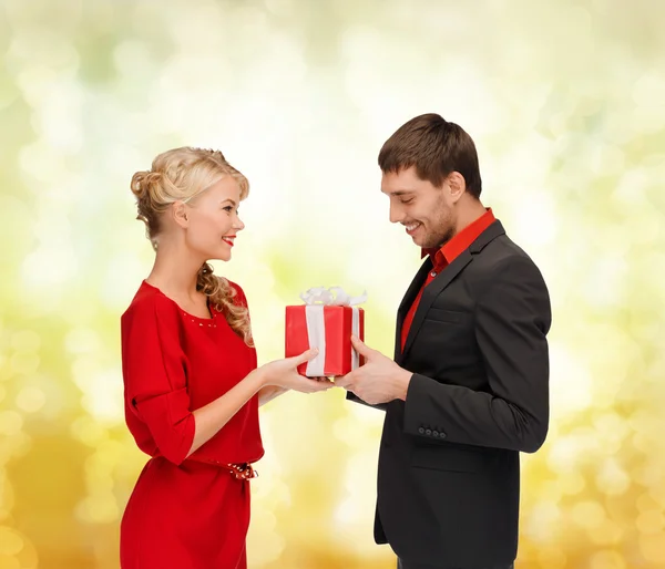 Mujer sonriente y hombre con caja de regalo — Foto de Stock