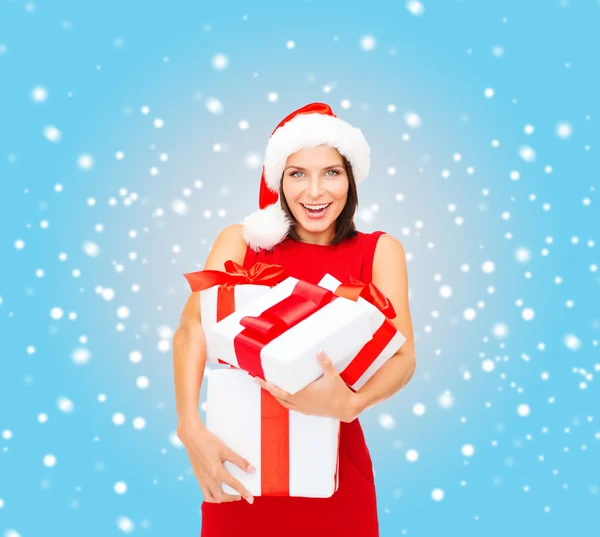 Woman in santa helper hat with many gift boxes — Stock Photo, Image