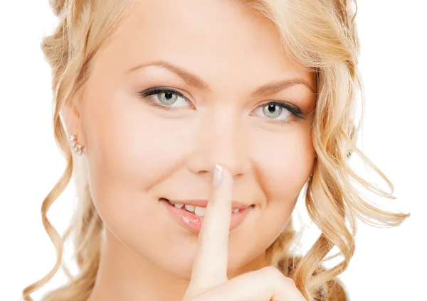 Frau mit Finger auf den Lippen — Stockfoto