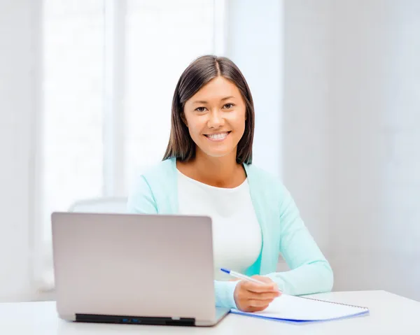 Asian businesswoman with laptop and documents — Stock Photo, Image