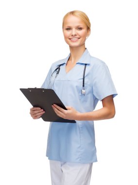 Smiling female doctor or nurse with clipboard clipart