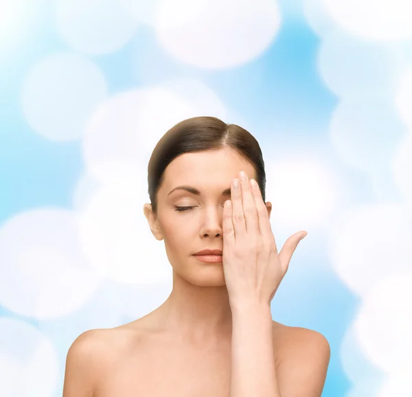 Calm young woman covering face with hand — Stock Photo, Image