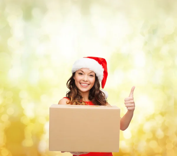 Smiling woman in santa helper hat with parcel box — Stock Photo, Image
